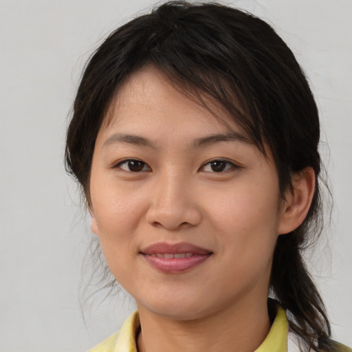 Joyful white young-adult female with medium  brown hair and brown eyes