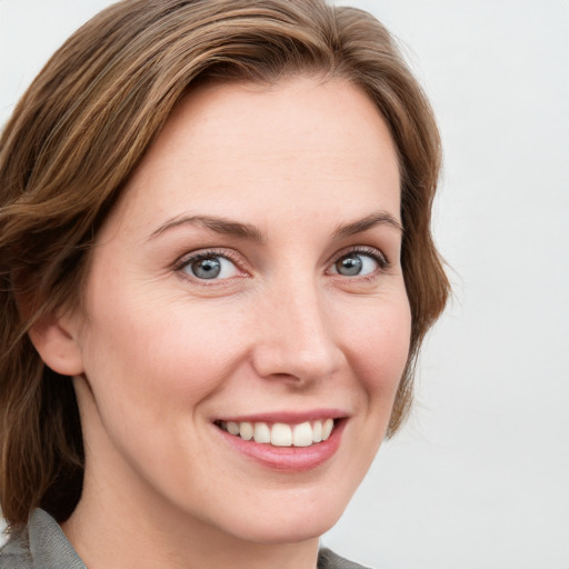 Joyful white young-adult female with medium  brown hair and blue eyes