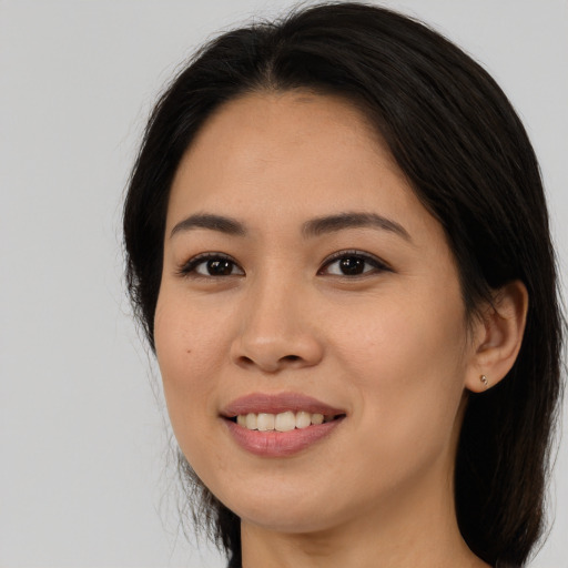Joyful asian young-adult female with long  brown hair and brown eyes