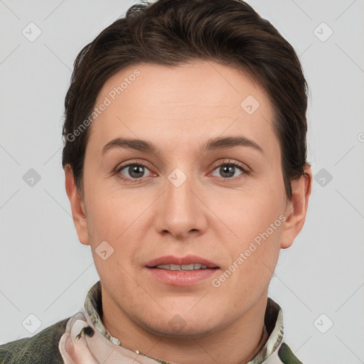 Joyful white young-adult female with short  brown hair and grey eyes