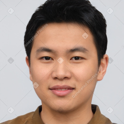 Joyful asian young-adult male with short  black hair and brown eyes