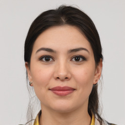 Joyful white young-adult female with medium  brown hair and brown eyes