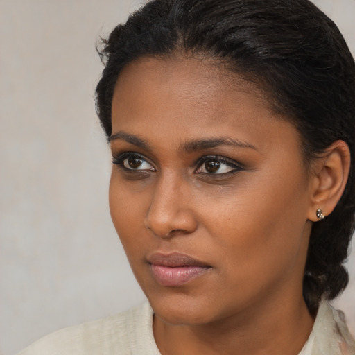 Neutral black young-adult female with medium  brown hair and brown eyes