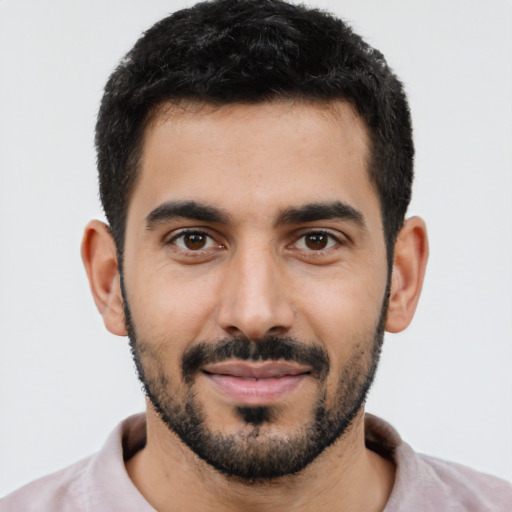 Joyful latino young-adult male with short  black hair and brown eyes