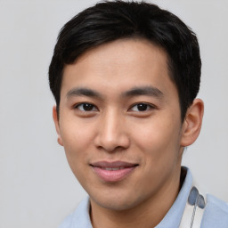 Joyful asian young-adult male with short  brown hair and brown eyes