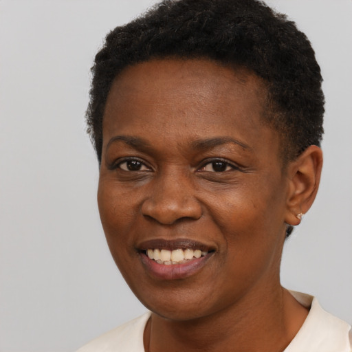 Joyful black young-adult female with short  black hair and brown eyes