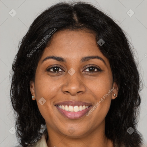 Joyful black young-adult female with long  brown hair and brown eyes