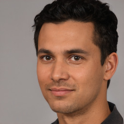 Joyful white young-adult male with short  black hair and brown eyes