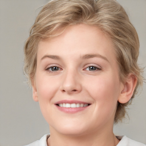 Joyful white young-adult female with medium  brown hair and blue eyes