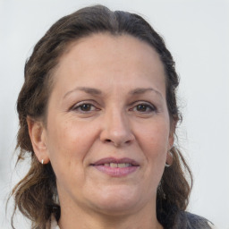 Joyful white adult female with medium  brown hair and grey eyes