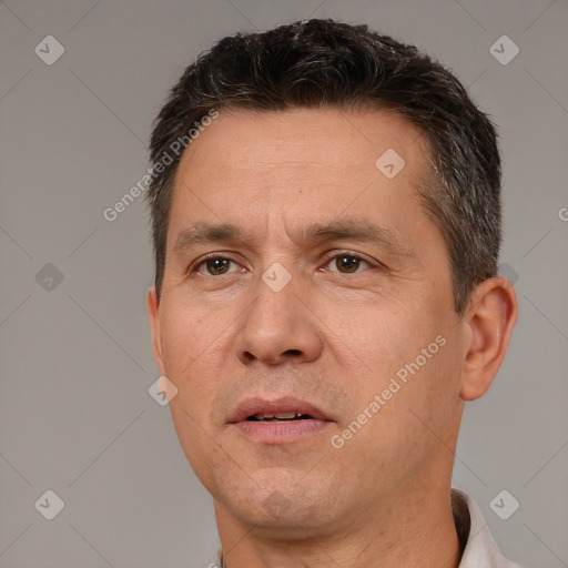 Joyful white adult male with short  brown hair and brown eyes