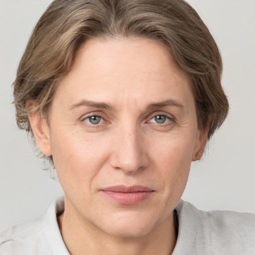 Joyful white adult female with short  brown hair and grey eyes