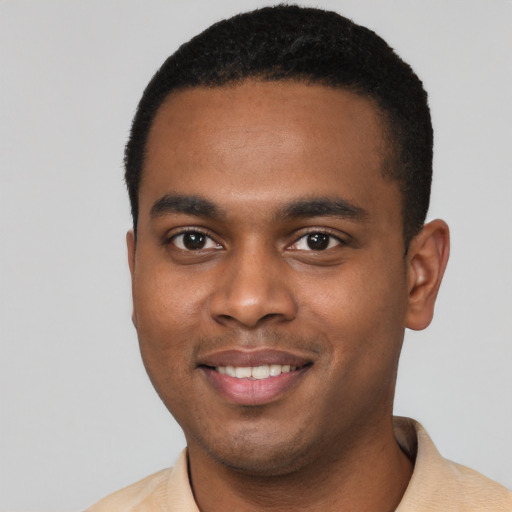 Joyful black young-adult male with short  black hair and brown eyes