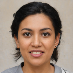 Joyful latino young-adult female with medium  brown hair and brown eyes