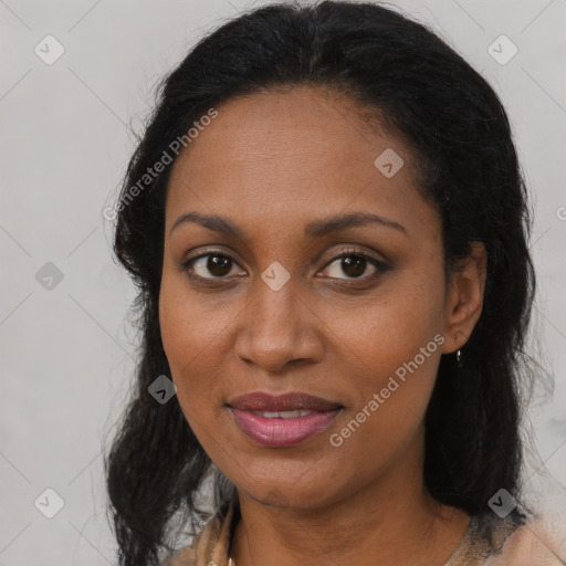 Joyful black adult female with long  brown hair and brown eyes