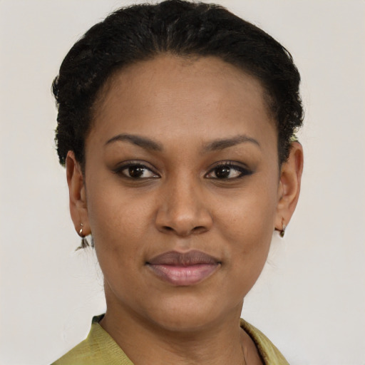 Joyful black young-adult female with short  brown hair and brown eyes