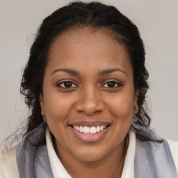 Joyful black young-adult female with long  brown hair and brown eyes