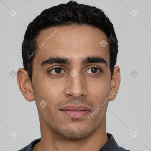Joyful latino young-adult male with short  black hair and brown eyes