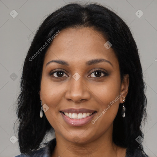 Joyful black young-adult female with long  black hair and brown eyes