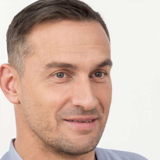 Joyful white adult male with short  brown hair and brown eyes