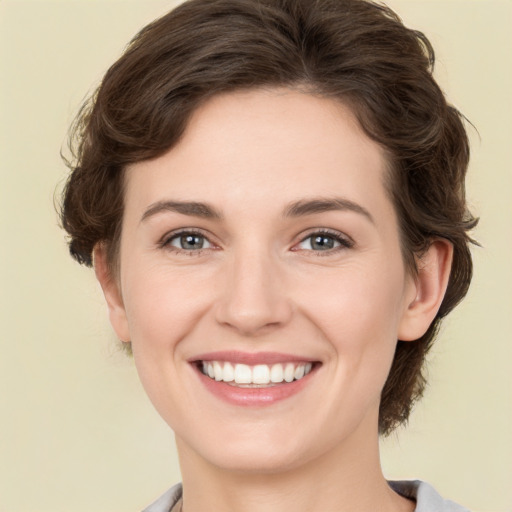 Joyful white young-adult female with medium  brown hair and green eyes