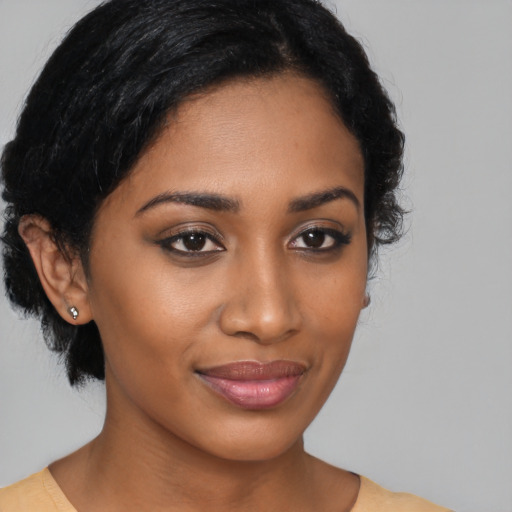 Joyful black young-adult female with medium  brown hair and brown eyes