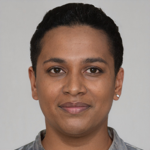 Joyful black young-adult female with short  black hair and brown eyes