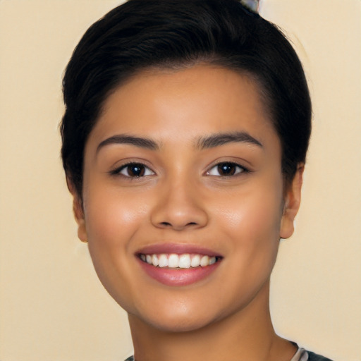 Joyful latino young-adult female with short  black hair and brown eyes