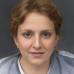 Joyful white young-adult female with medium  brown hair and grey eyes