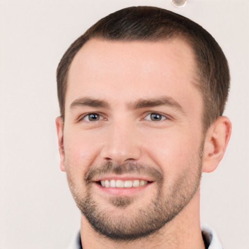 Joyful white young-adult male with short  brown hair and brown eyes