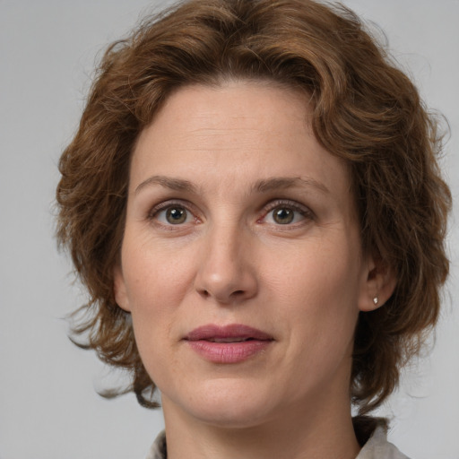 Joyful white young-adult female with medium  brown hair and green eyes