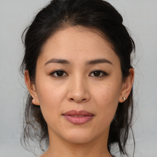 Joyful asian young-adult female with medium  brown hair and brown eyes