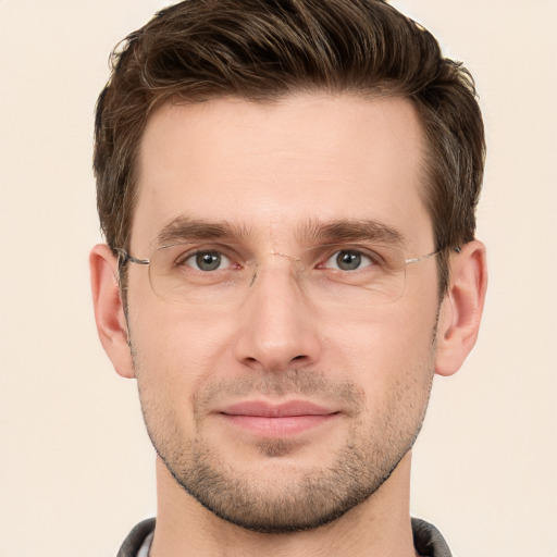 Joyful white young-adult male with short  brown hair and grey eyes