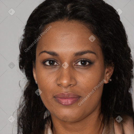 Joyful black adult female with long  brown hair and brown eyes