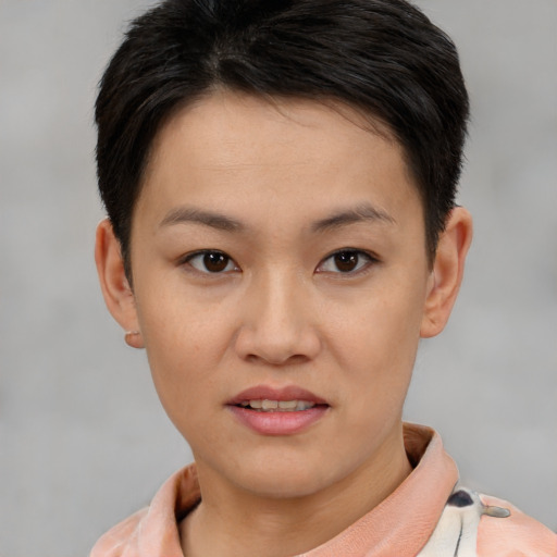 Joyful asian young-adult female with short  brown hair and brown eyes