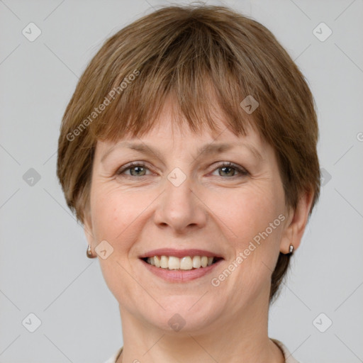 Joyful white adult female with short  brown hair and grey eyes