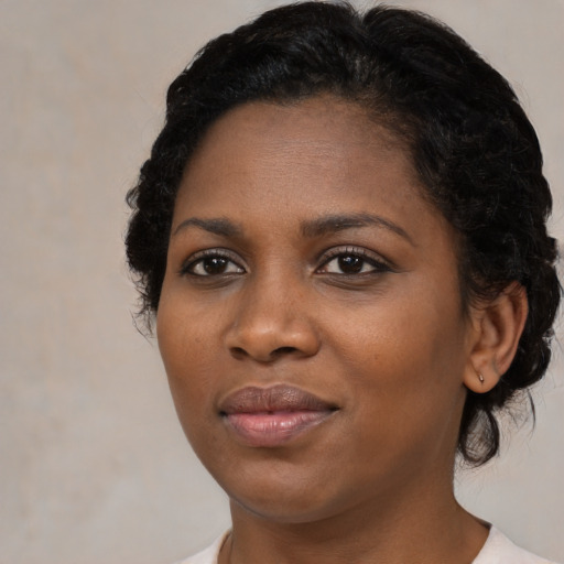 Joyful black young-adult female with medium  black hair and brown eyes