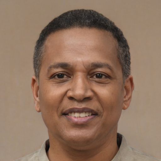 Joyful latino adult male with short  brown hair and brown eyes
