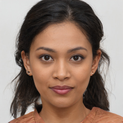 Joyful latino young-adult female with medium  brown hair and brown eyes