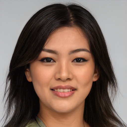 Joyful asian young-adult female with long  brown hair and brown eyes