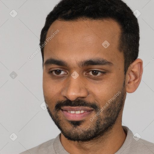 Joyful black young-adult male with short  black hair and brown eyes