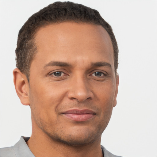 Joyful white adult male with short  brown hair and brown eyes