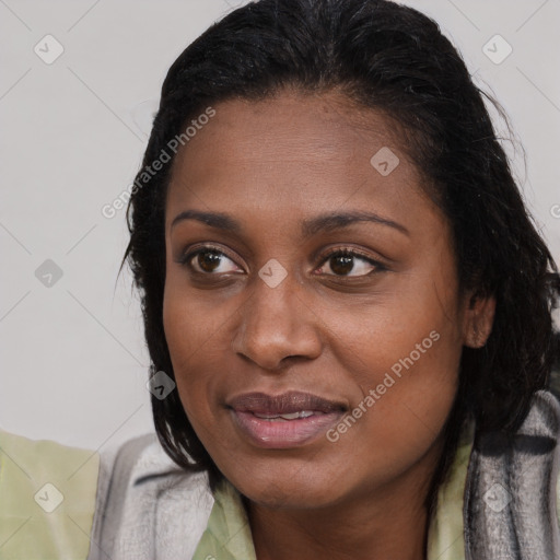 Joyful black young-adult female with long  brown hair and brown eyes