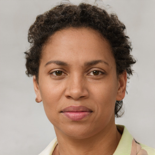 Joyful latino adult female with short  brown hair and brown eyes