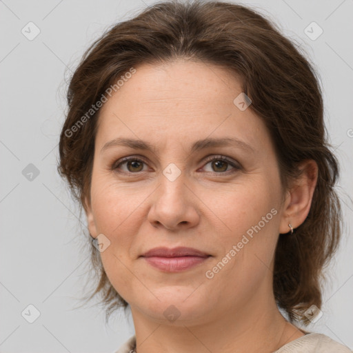 Joyful white adult female with medium  brown hair and brown eyes