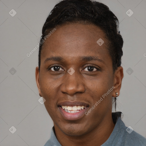 Joyful black adult male with short  brown hair and brown eyes