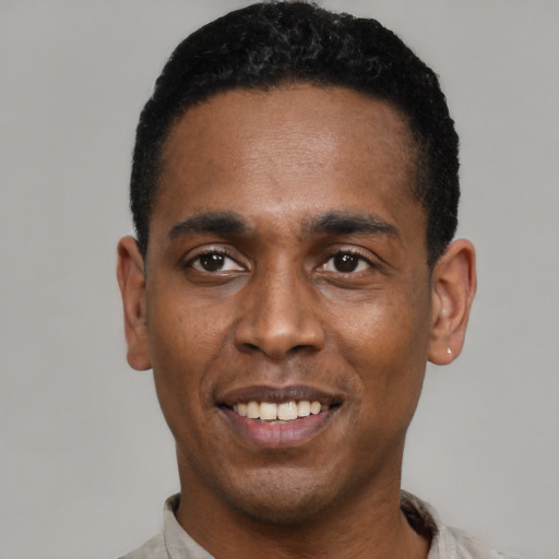 Joyful black young-adult male with short  black hair and brown eyes
