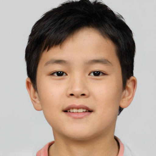 Joyful asian child male with short  brown hair and brown eyes