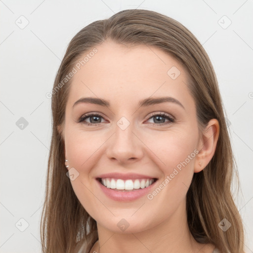 Joyful white young-adult female with long  brown hair and grey eyes