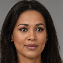 Joyful latino young-adult female with long  brown hair and brown eyes